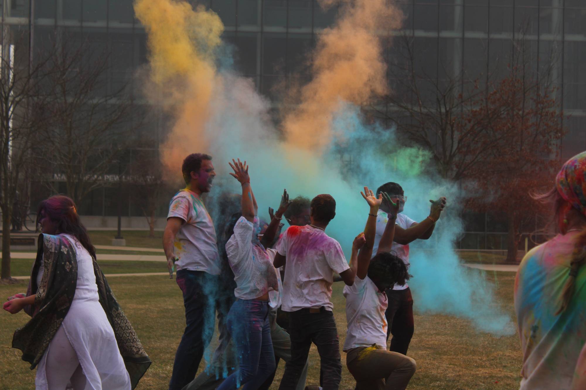 Students throw powder to celebrate Holi